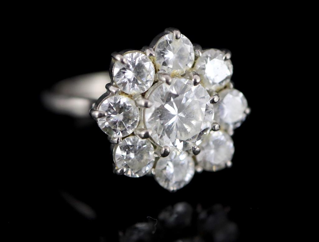 A 1970s 18ct white gold and nine stone diamond cluster ring,